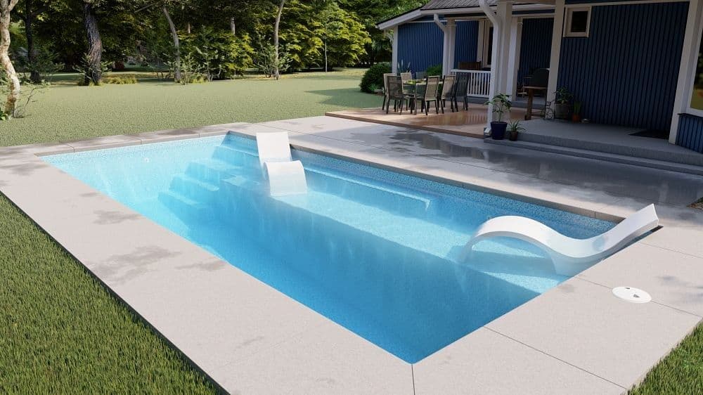Liberty Anthem fiberglass pool, rectangular pool seen from the deep end toward the tanning ledge and entry steps, with a lawn and a blue house behind, manufacturer photo.